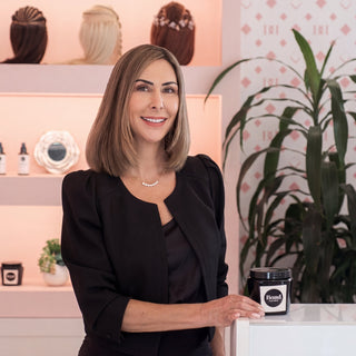 Emily Wyant, founder of Bond Hair Bar, at the extensions counter with aftercare product in San Mateo
