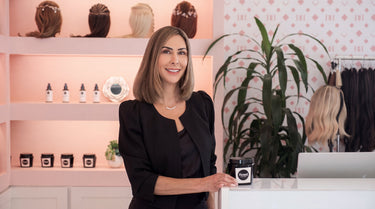 Emily Wyant, founder of Bond Hair Bar, at the extensions counter with aftercare product in San Mateo