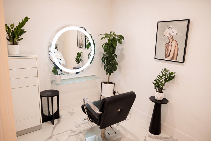 Private room with lit mirror and styling chair at Bond Hair Bar in San Mateo